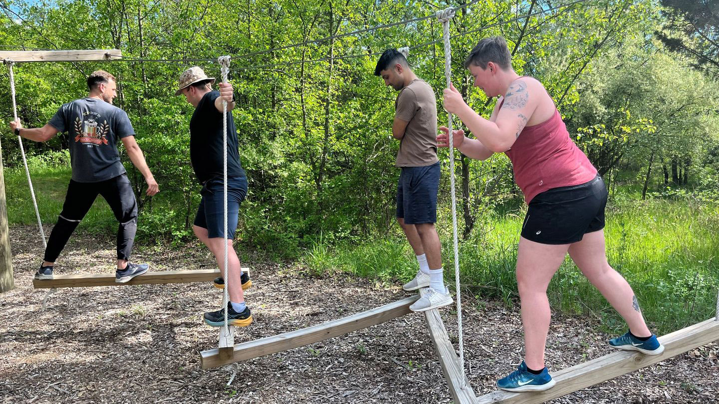 Students participating in the challenge course crossing obstacles