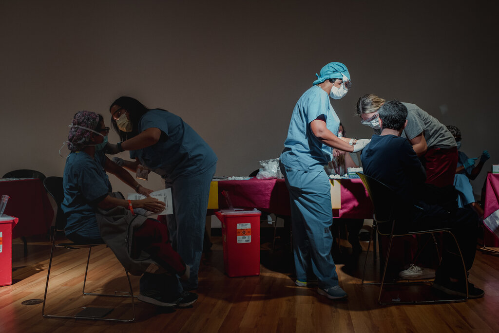 Some Health Care Workers Are Getting the Vaccine. Others Aren’t. Who Decides?