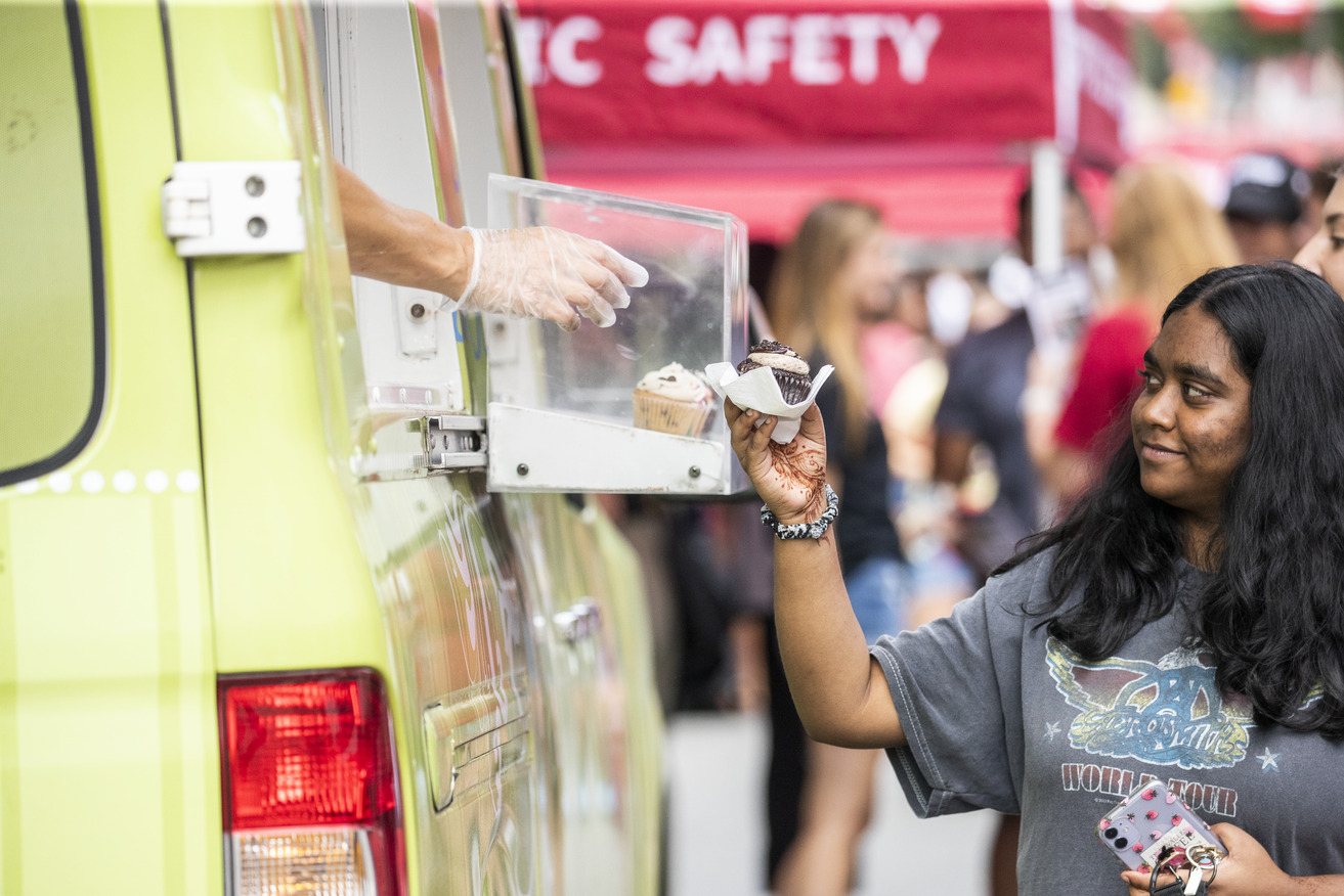 Student taking ice cream from food truck